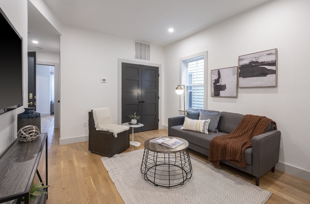 43 Wordsworth Street, Unit 2 Boston, MA 02128 - Photo 8 of 12 a living room with furniture and a flat screen tv