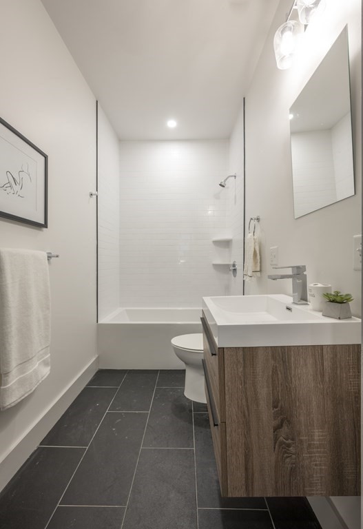 43 Wordsworth Street, Unit 2 Boston, MA 02128 - Photo 10 of 12 a bathroom with a sink a toilet and a mirror