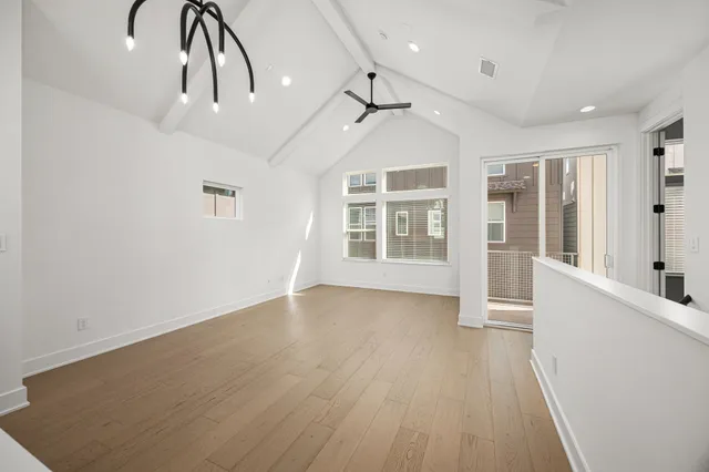 a large kitchen with a lot of counter space and wooden floor