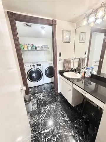 a bathroom with a double vanity sink and a mirror
