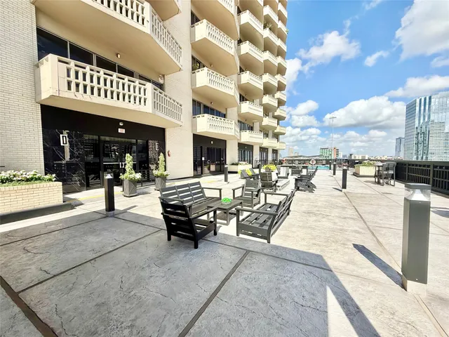 a view of a patio with dining table and chairs