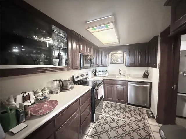 a kitchen with granite countertop wooden cabinets and white appliances