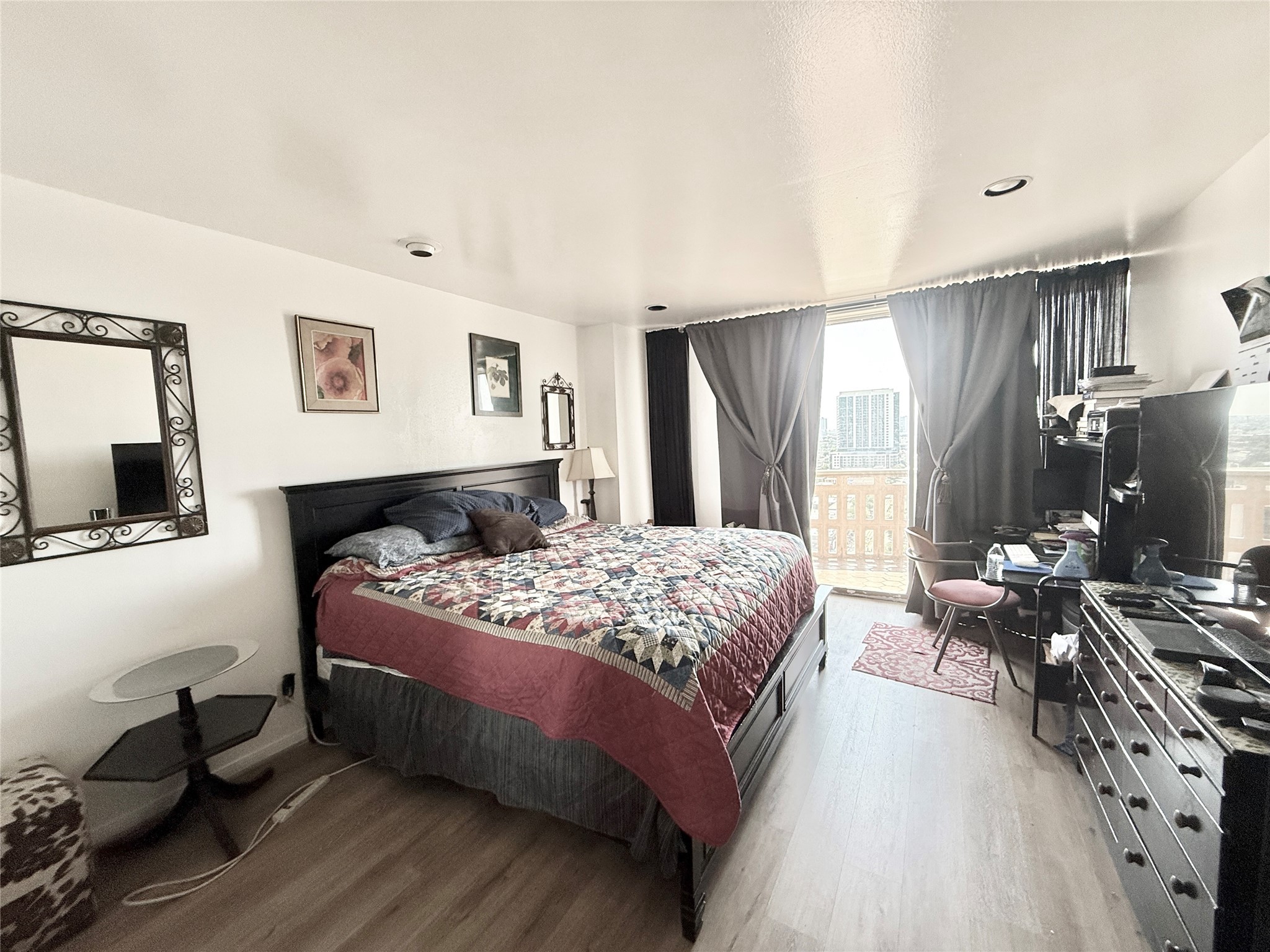 2016 Main Street, Unit 1704 Houston, TX 77002 - Photo 8 of 38 a bedroom with a bed and wooden floor