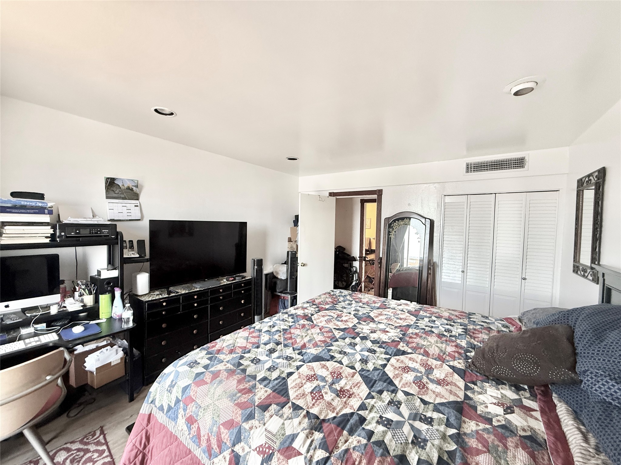 2016 Main Street, Unit 1704 Houston, TX 77002 - Photo 10 of 38 a bedroom with a bed and a flat screen tv