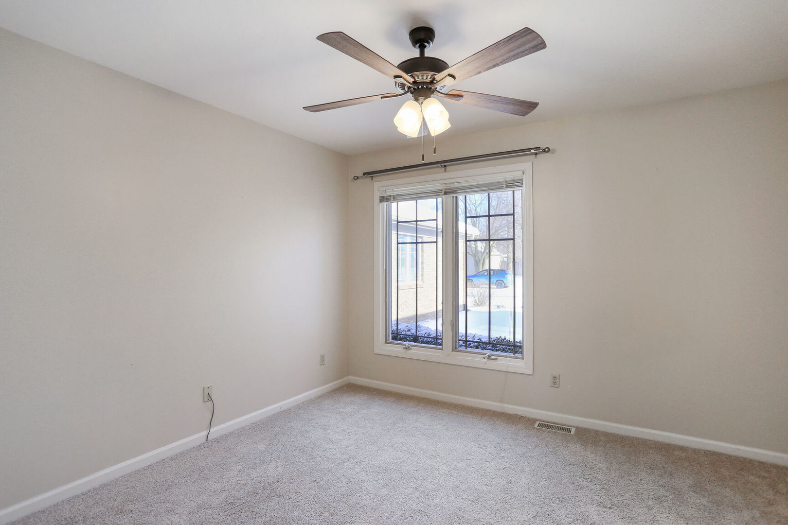1731 Lakeside Drive, Unit B Champaign, IL 61821 - Photo 12 of 21 an empty room with windows and fan