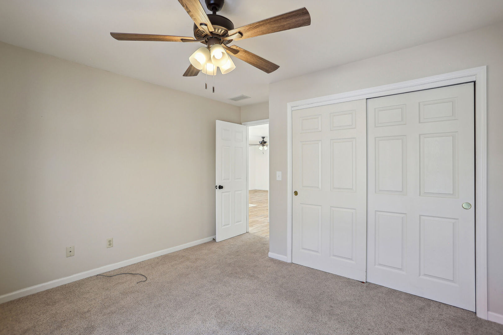 1731 Lakeside Drive, Unit B Champaign, IL 61821 - Photo 13 of 21 an empty room with a ceiling fan