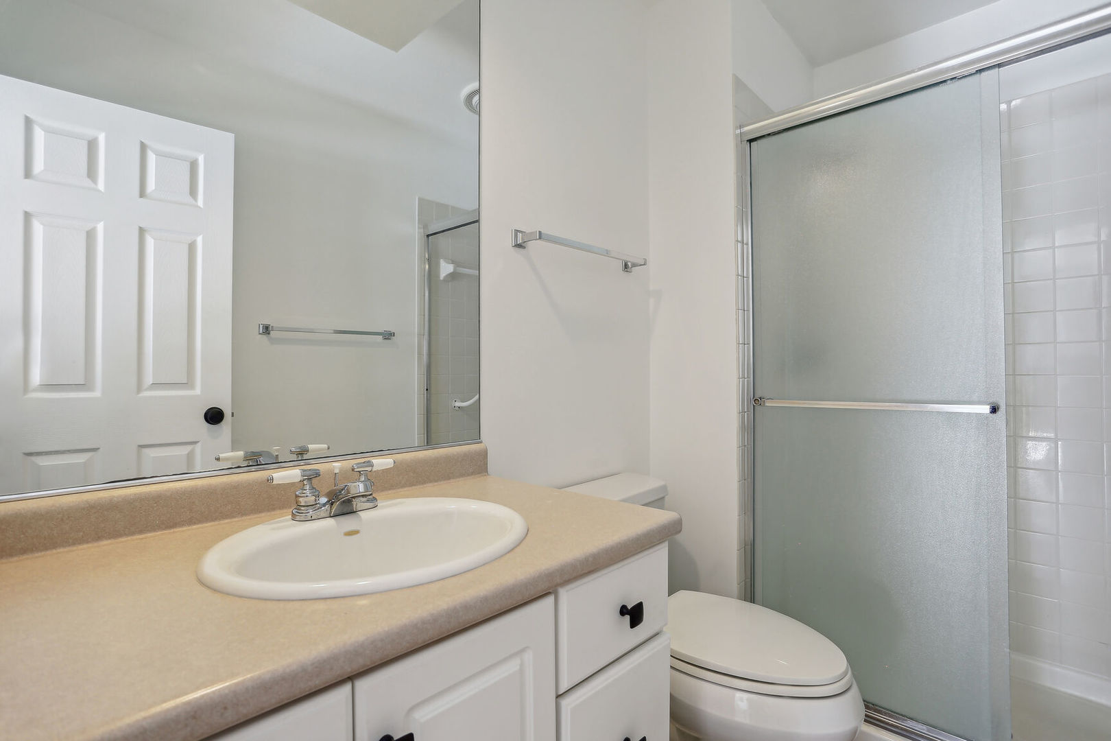 1731 Lakeside Drive, Unit B Champaign, IL 61821 - Photo 14 of 21 a bathroom with a sink toilet a mirror and shower