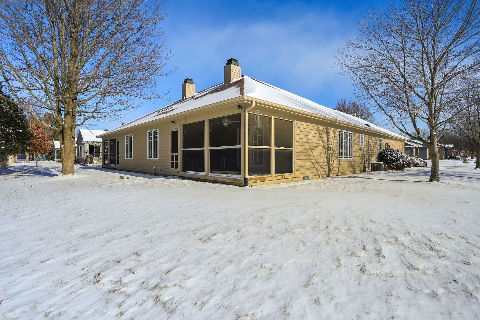 1731 Lakeside Drive, Unit B Champaign, IL 61821 - Photo 18 of 21 a view of a house with a yard covered in snow