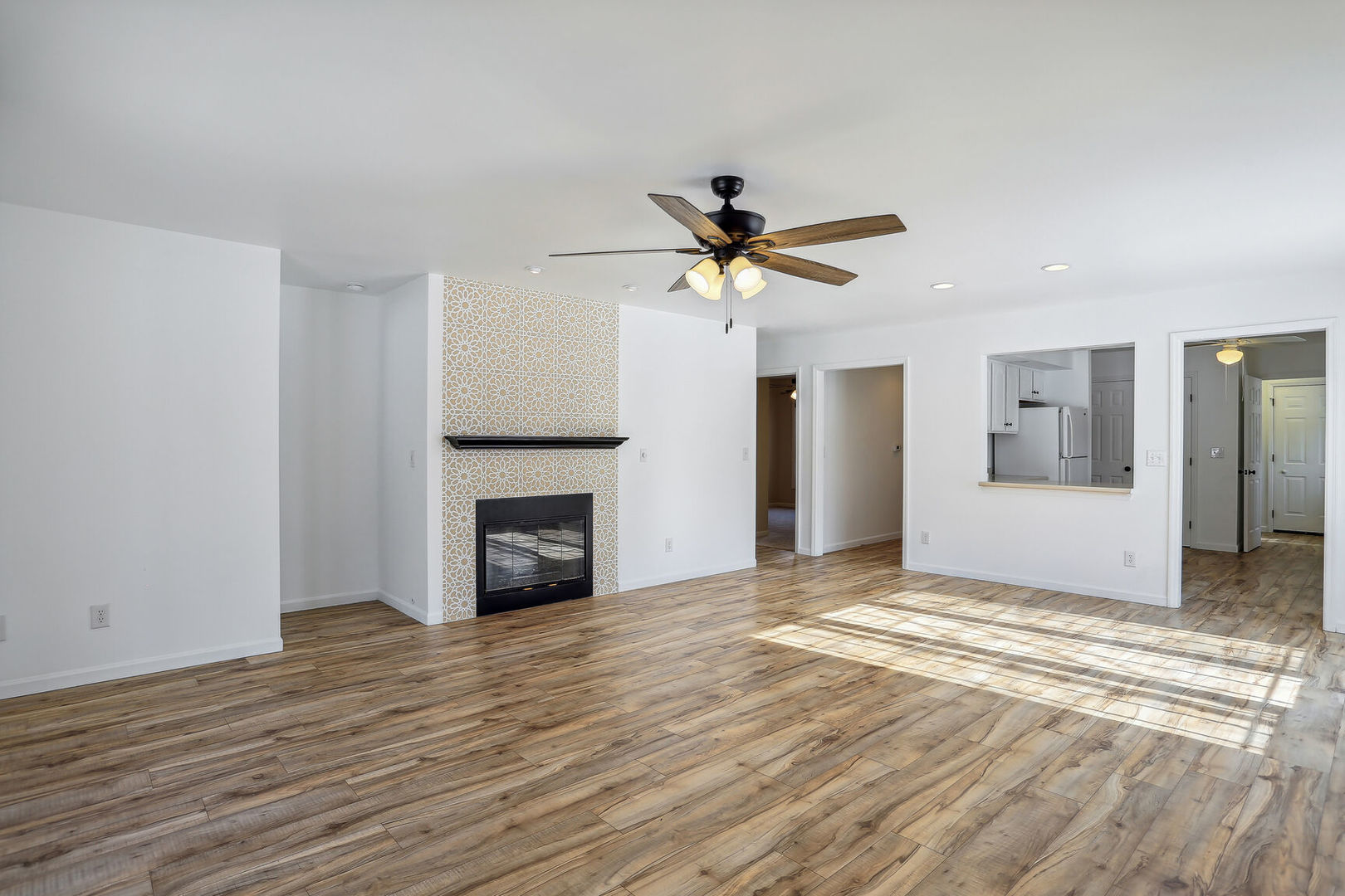 1731 Lakeside Drive, Unit B Champaign, IL 61821 - Photo 2 of 21 a view of a livingroom with a fireplace and a ceiling fan