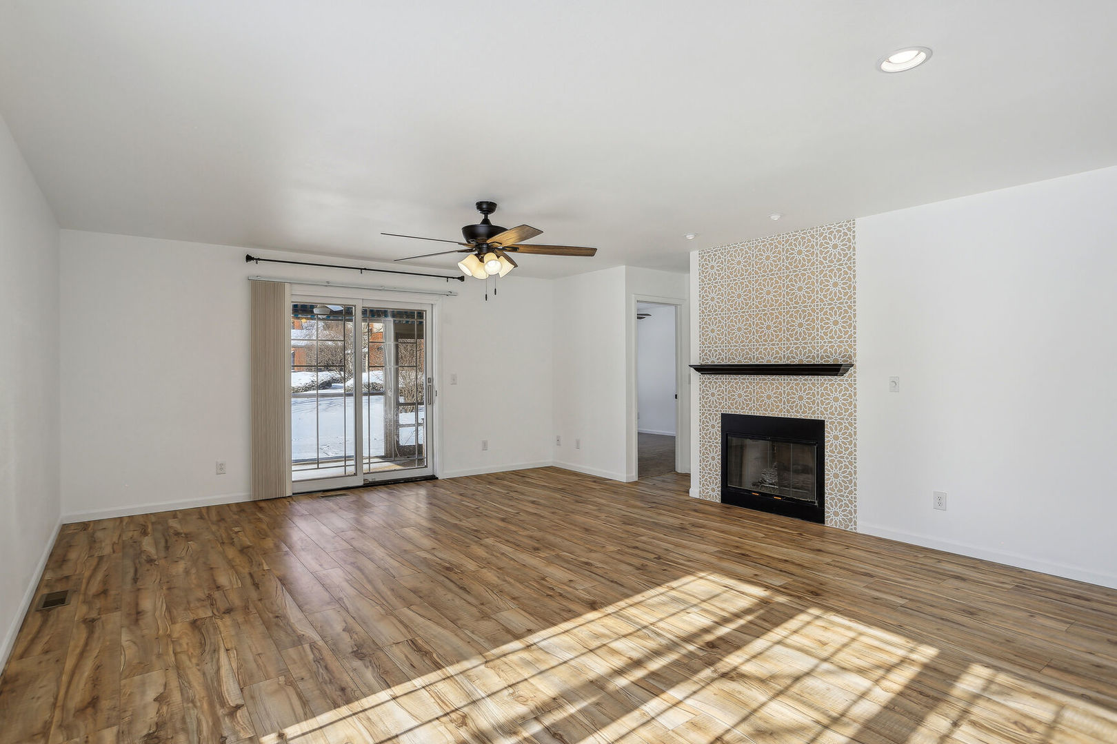 1731 Lakeside Drive, Unit B Champaign, IL 61821 - Photo 3 of 21 a view of empty room with wooden floor and fireplace