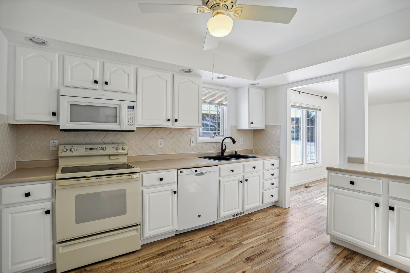 1731 Lakeside Drive, Unit B Champaign, IL 61821 - Photo 6 of 21 a kitchen with white cabinets white stainless steel appliances and sink