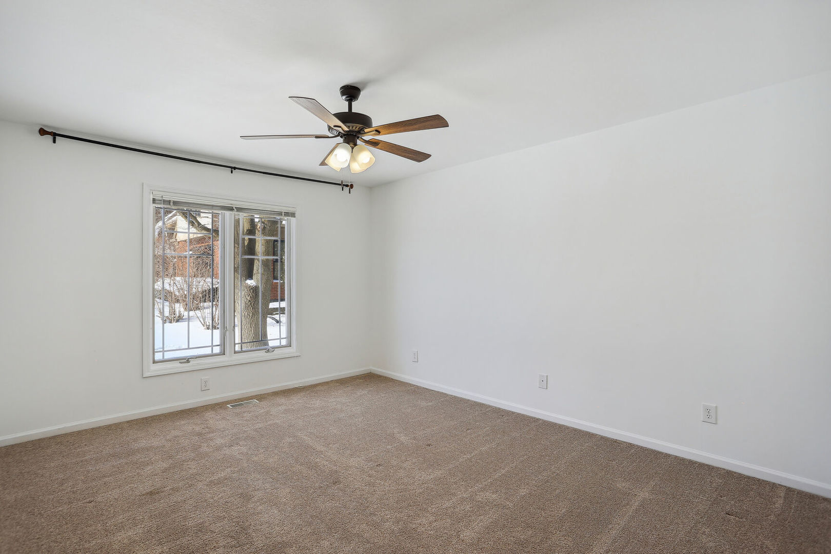 1731 Lakeside Drive, Unit B Champaign, IL 61821 - Photo 8 of 21 an empty room with a window and a fan