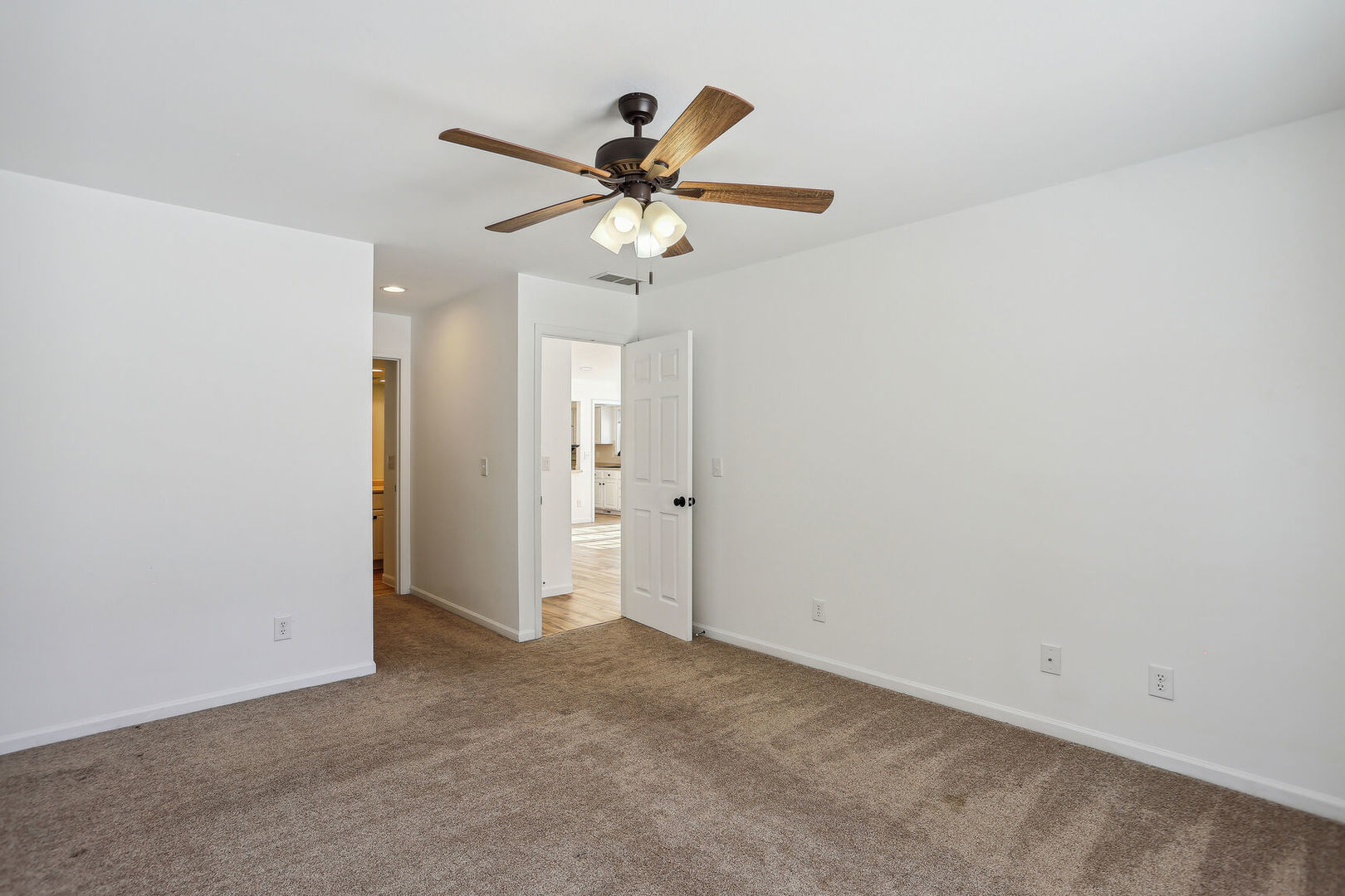 1731 Lakeside Drive, Unit B Champaign, IL 61821 - Photo 9 of 21 an empty room with closet and a chandelier fan