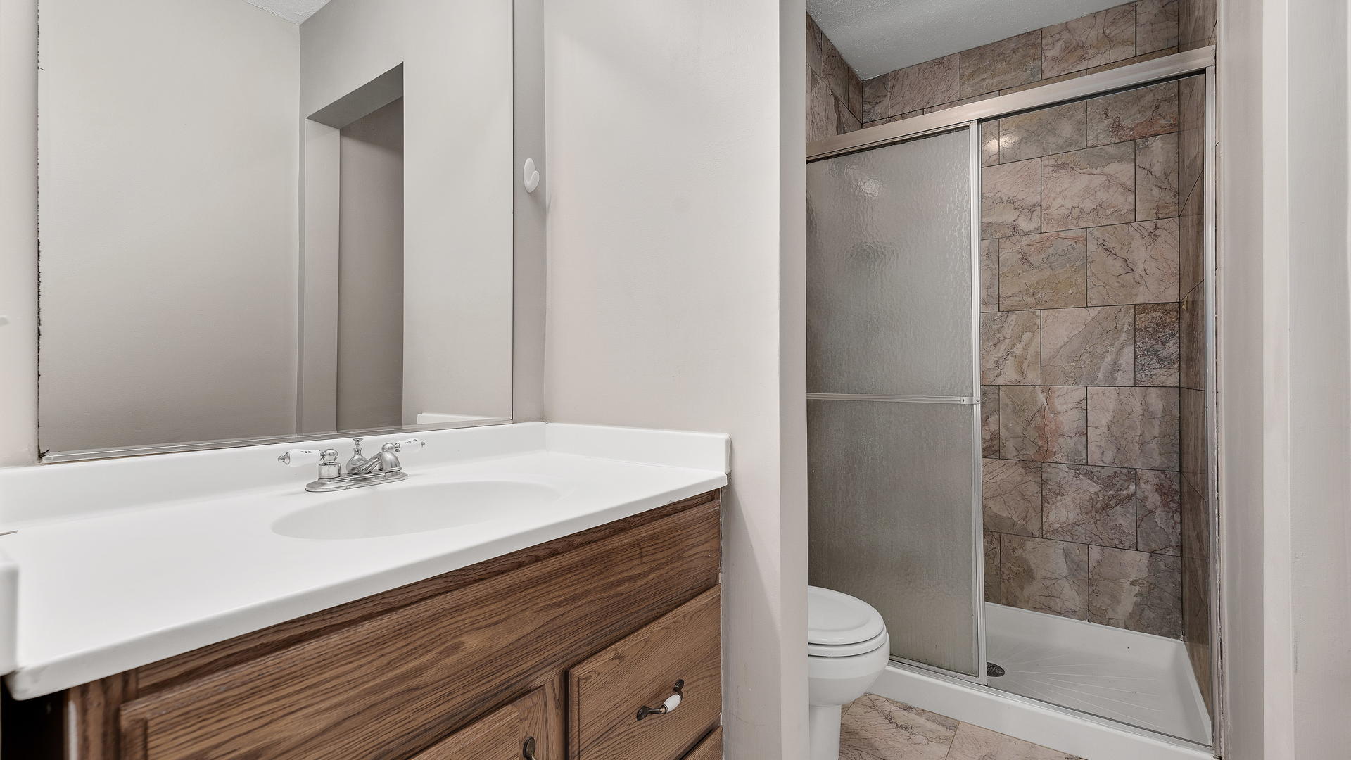 792 Oregon Trail Roselle, IL 60172 - Photo 11 of 19 a bathroom with a sink a toilet a mirror and shower