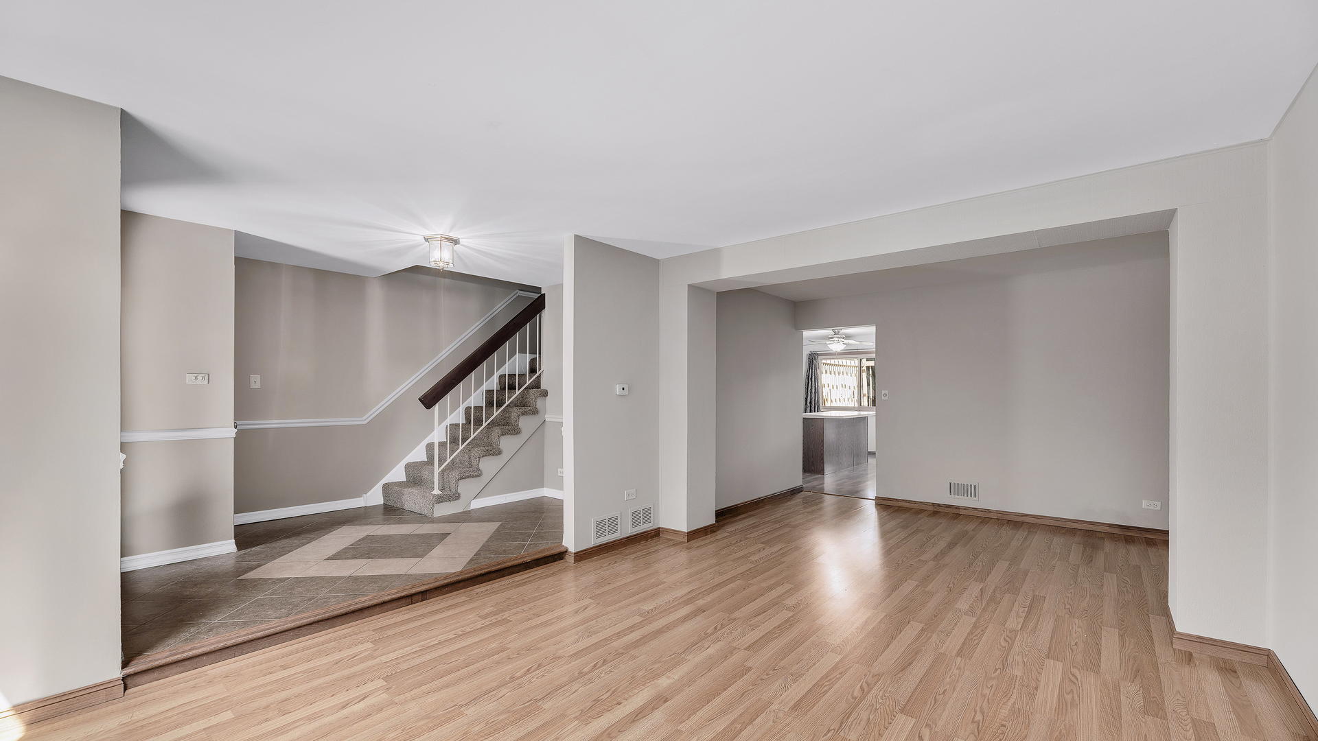 792 Oregon Trail Roselle, IL 60172 - Photo 7 of 19 a view of an empty room with wooden floor and stairs