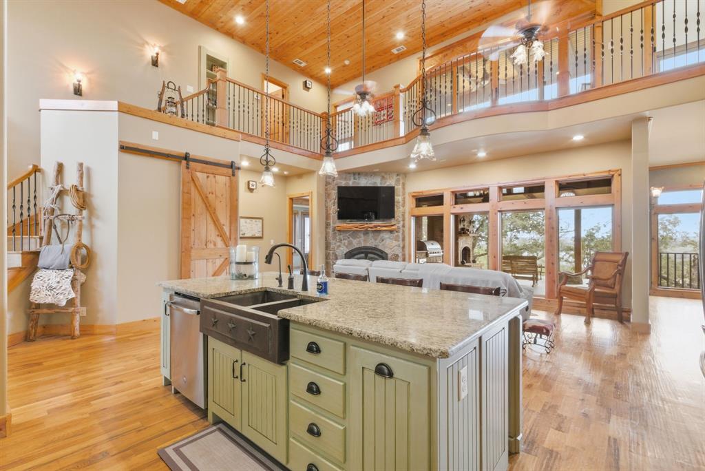 735 Gresham Lane Jacksboro, TX 76458 - Photo 12 of 40 a kitchen with stainless steel appliances granite countertop a sink and a stove