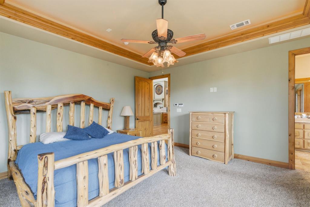 735 Gresham Lane Jacksboro, TX 76458 - Photo 13 of 40 a bedroom with furniture and a chandelier