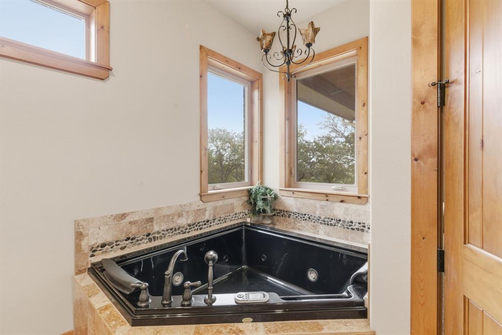 735 Gresham Lane Jacksboro, TX 76458 - Photo 15 of 40 a bathroom with a sink and a mirror