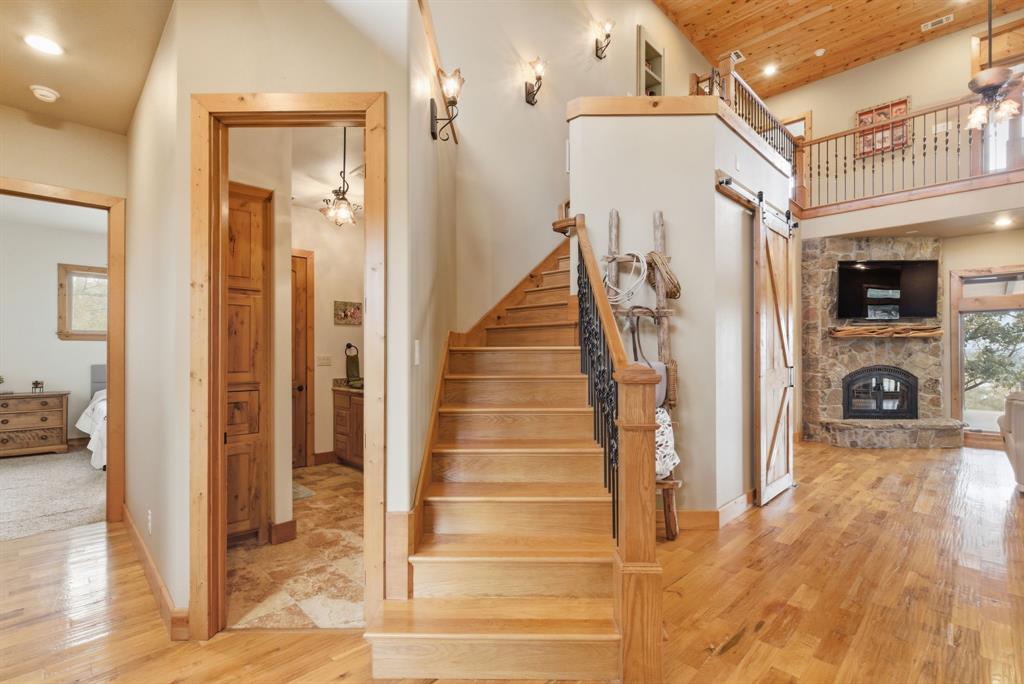 735 Gresham Lane Jacksboro, TX 76458 - Photo 17 of 40 a view of a hallway with wooden floor and staircase