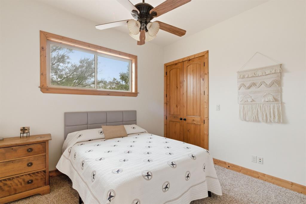 735 Gresham Lane Jacksboro, TX 76458 - Photo 19 of 40 a bedroom with a bed and a painting on the wall