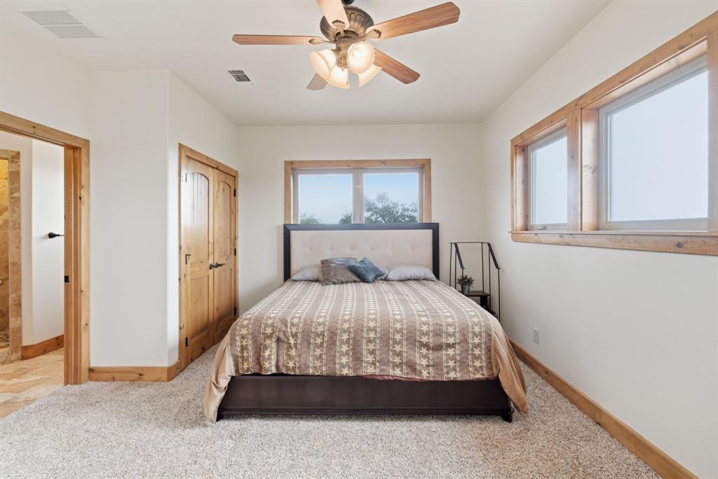 735 Gresham Lane Jacksboro, TX 76458 - Photo 21 of 40 a bed sitting in a bedroom next to a window