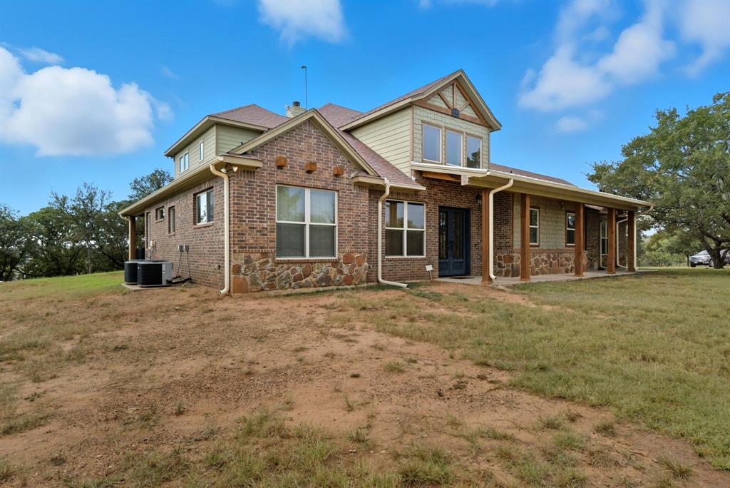 735 Gresham Lane Jacksboro, TX 76458 - Photo 26 of 40 a view of a yard in front of a house with large trees