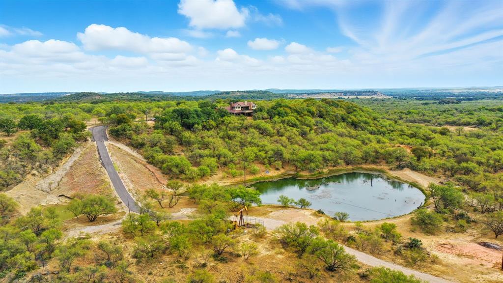735 Gresham Lane Jacksboro, TX 76458 - Photo 32 of 40 a view of a swimming pool with a yard and mountain view