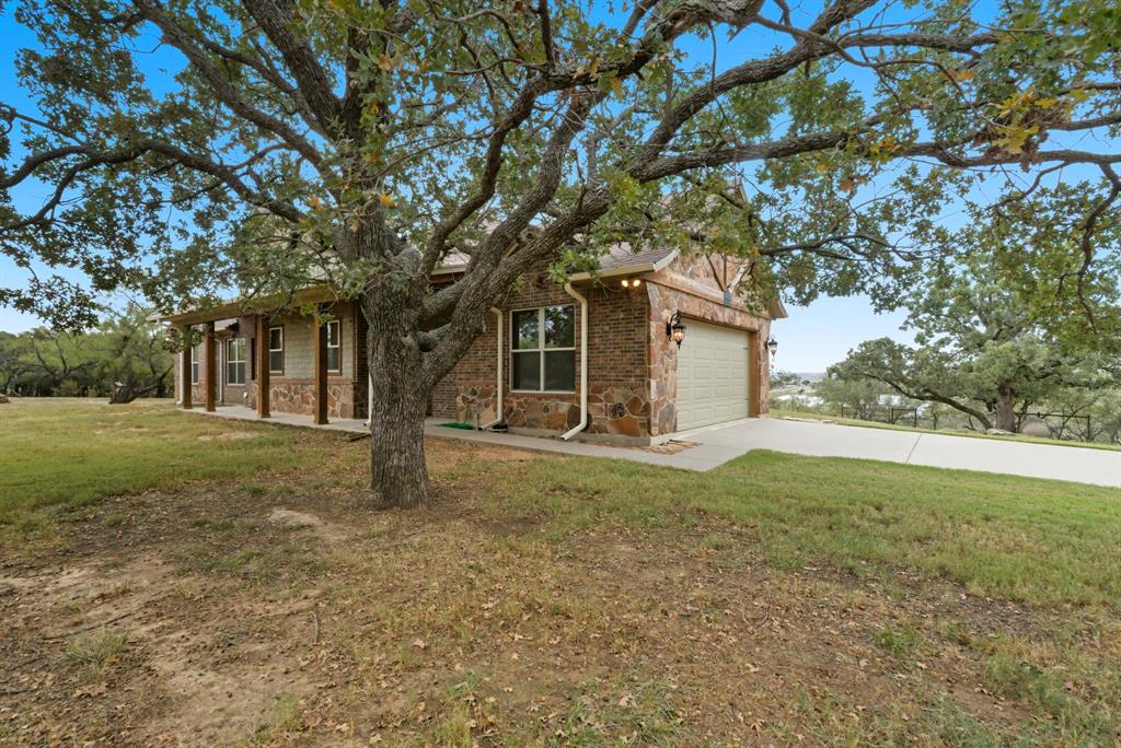 735 Gresham Lane Jacksboro, TX 76458 - Photo 5 of 40 a view of a house with yard and a tree