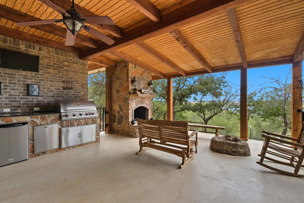 735 Gresham Lane Jacksboro, TX 76458 - Photo 6 of 40 a outdoor space with the couches and dining table under an umbrella