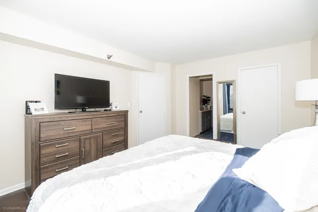 a bedroom with a bed and a flat screen tv