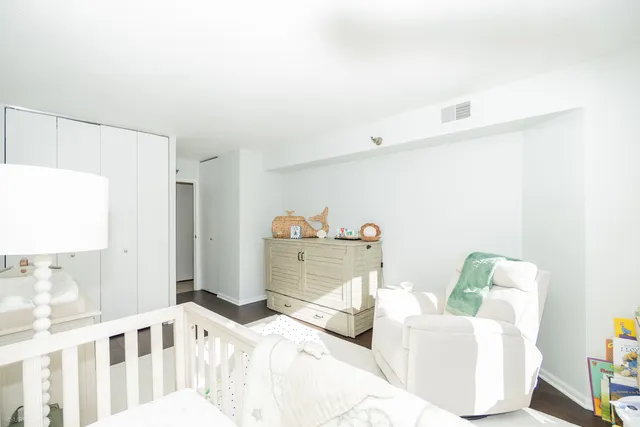 a bedroom with furniture and a wooden floor
