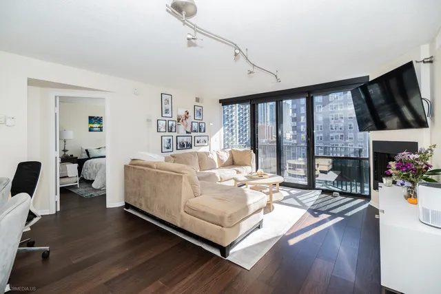 a living room with furniture fireplace and flat screen tv