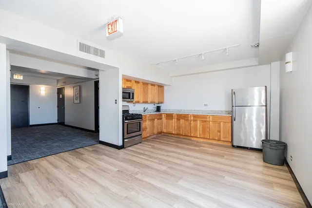 a living room with furniture and a dining table