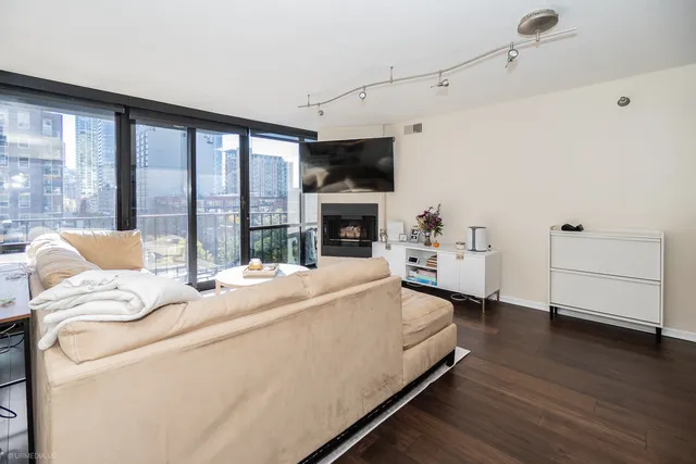 a bed sitting in a spacious bedroom next to a window