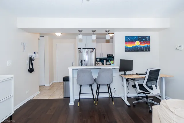 a view of a workspace with furniture and wooden floor