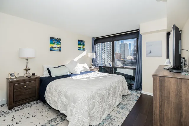 a bedroom with a bed and a tv on table