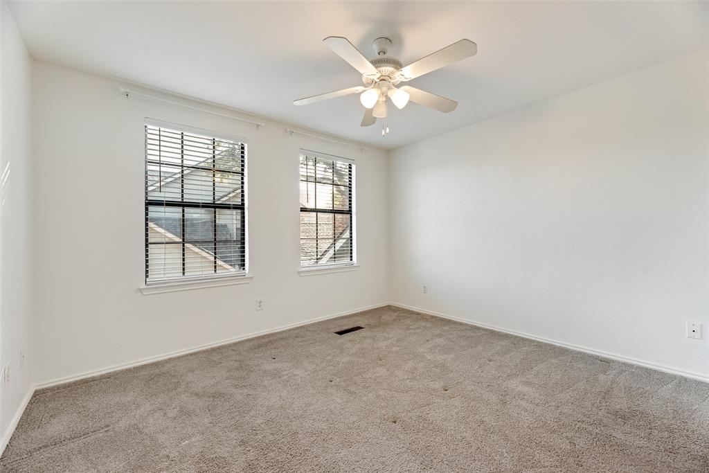 449 Harris Street, Unit 101L Coppell, TX 75019 - Photo 12 of 22 an empty room with windows and fan