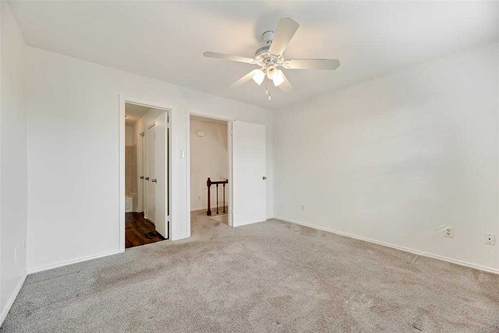 449 Harris Street, Unit 101L Coppell, TX 75019 - Photo 13 of 22 a view of an empty room with a fan