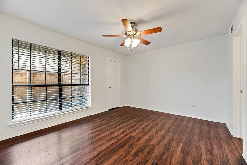 449 Harris Street, Unit 101L Coppell, TX 75019 - Photo 15 of 22 a view of an empty room with wooden floor and a window