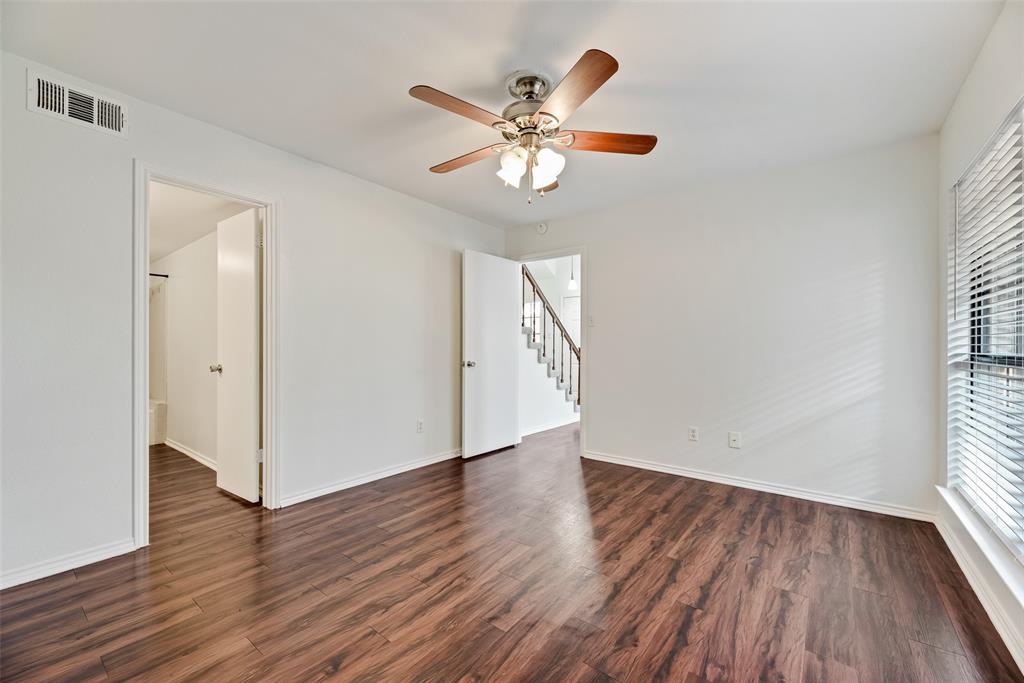 449 Harris Street, Unit 101L Coppell, TX 75019 - Photo 16 of 22 an empty room with wooden floor fan and windows