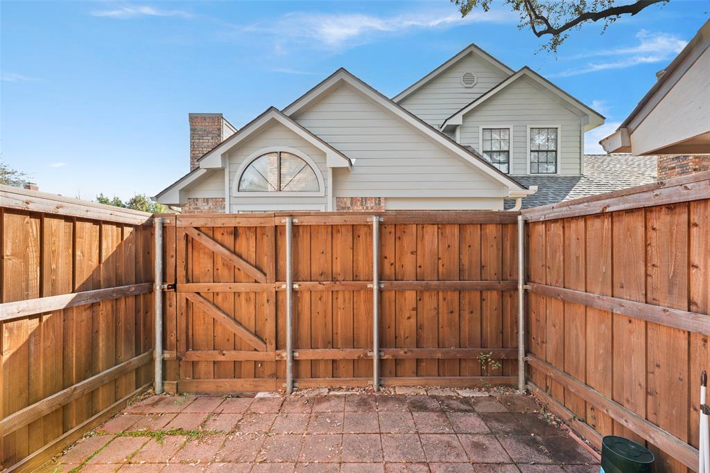 449 Harris Street, Unit 101L Coppell, TX 75019 - Photo 20 of 22 a view of a small house with wooden fence