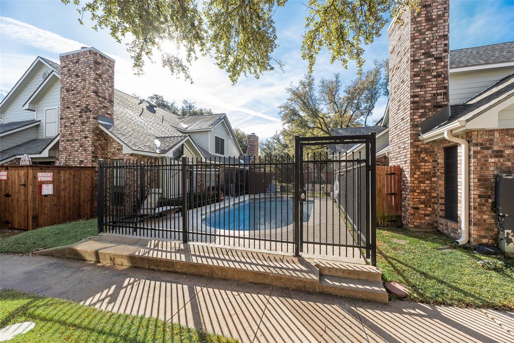 449 Harris Street, Unit 101L Coppell, TX 75019 - Photo 21 of 22 a view of a brick house with a small yard and plants