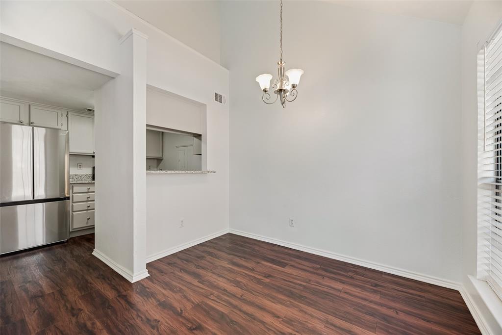449 Harris Street, Unit 101L Coppell, TX 75019 - Photo 7 of 22 a view of a kitchen with wooden floor and a ceiling fan