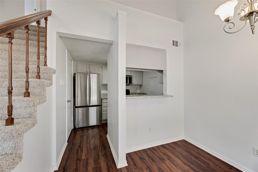 449 Harris Street, Unit 101L Coppell, TX 75019 - Photo 8 of 22 a view of a hallway with wooden floor and staircase