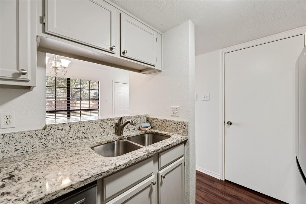 449 Harris Street, Unit 101L Coppell, TX 75019 - Photo 10 of 22 a kitchen with granite countertop a sink and a window