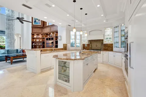 a living room with furniture and a kitchen view