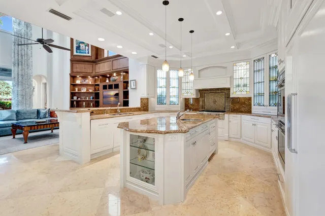 a living room with furniture and a kitchen view