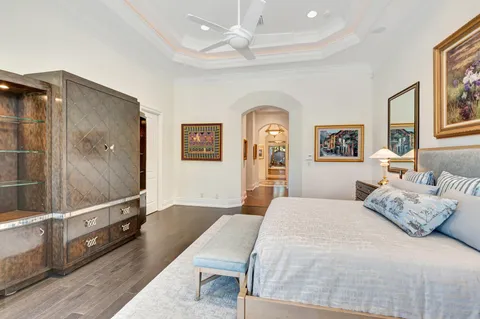 a dining hall with stainless steel appliances granite countertop a couch and chandelier