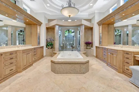 a living room with furniture a rug and a chandelier