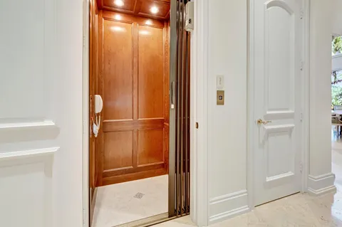 a bathroom with a granite countertop sink a toilet a mirror and shower